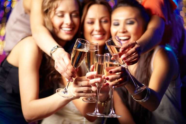 Cheerful,Girls,Clinking,Glasses,Of,Champagne,At,The,Party