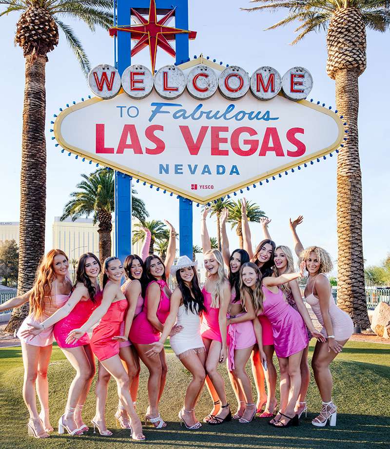 Gilrs Under Vegas Sign